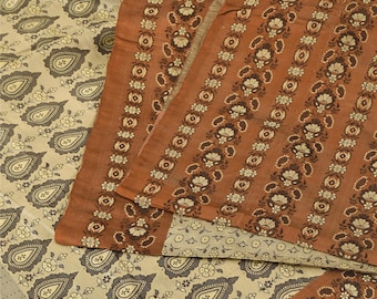 May include: A textile fabric featuring two distinct patterns. One section displays a cream background with dark brown paisley motifs and small floral accents. The other section consists of vertical stripes in a rust-orange hue with repeating floral patterns.