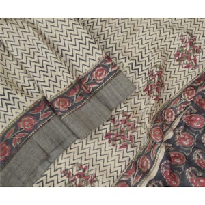 May include: Cream-colored fabric with a repeating navy blue chevron pattern. The border features a floral design in red and navy blue. A section of the fabric has a gray border with a floral pattern.