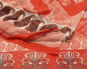 May include: A red and white patterned fabric with a paisley design. The fabric is folded in half and has a fringed edge.
