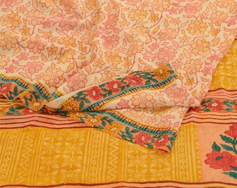May include: A yellow and orange fabric with a floral pattern. The fabric has a border with a floral design in shades of pink, green, and blue.