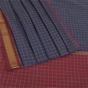 May include: A navy blue and burgundy saree with a grid pattern. The saree features a gold border with intricate designs. The fabric is draped, showcasing the texture and color variations. The saree is a traditional garment.