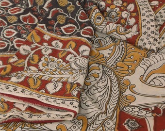 May include: A textile fabric featuring a block-printed pattern with intricate floral and leaf motifs in shades of deep red, mustard yellow, and black on an off-white background. The design includes repeating botanical elements and borders.