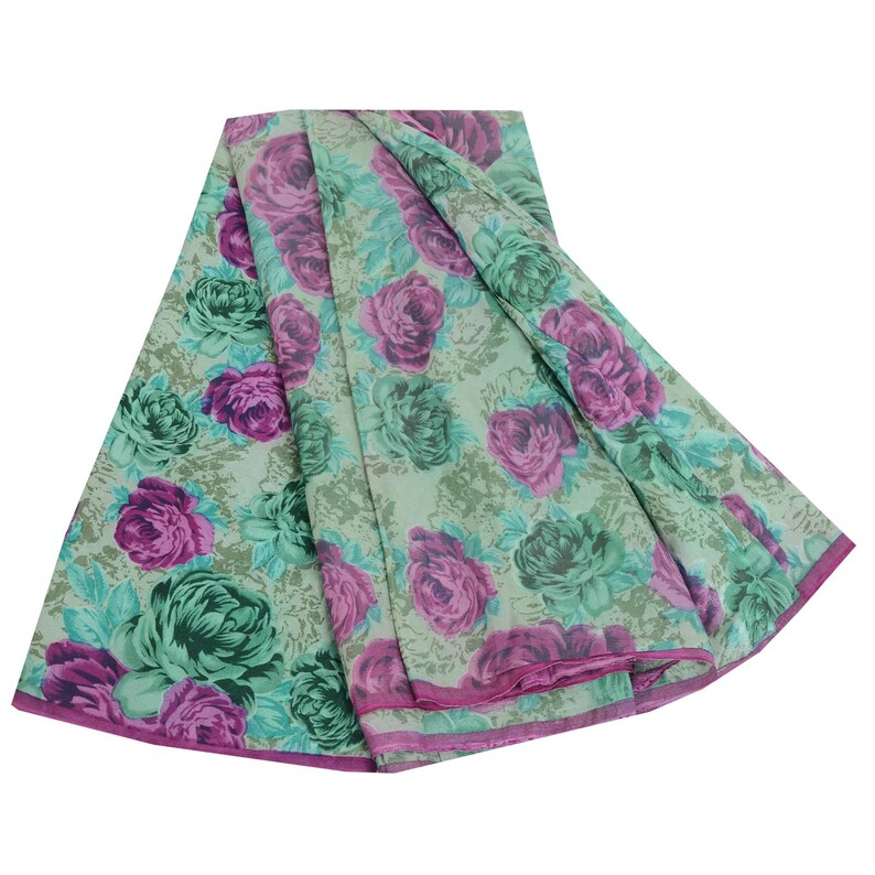 May include: A green and pink floral print fabric with a sheer texture. The fabric is folded in a circular shape.