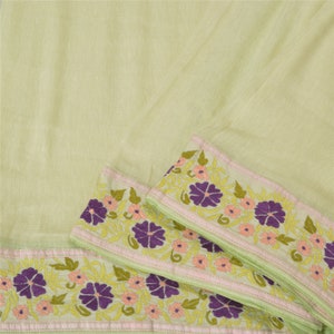 May include: Pale green fabric with a floral embroidered border. The embroidery is in shades of pink, green, and purple.