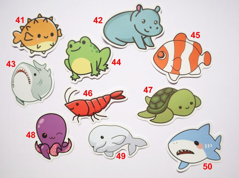 May include: A set of 10 colorful cartoon animal stickers. The stickers feature a pufferfish, frog, hippopotamus, clownfish, shark, shrimp, turtle, octopus, beluga whale, and a shark. The stickers are numbered 41 through 50.