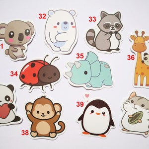 May include: A set of ten cute animal stickers, including a koala, polar bear, raccoon, giraffe, triceratops, ladybug, panda, monkey, penguin, and hamster. The stickers are all in cartoon style and have a white background.