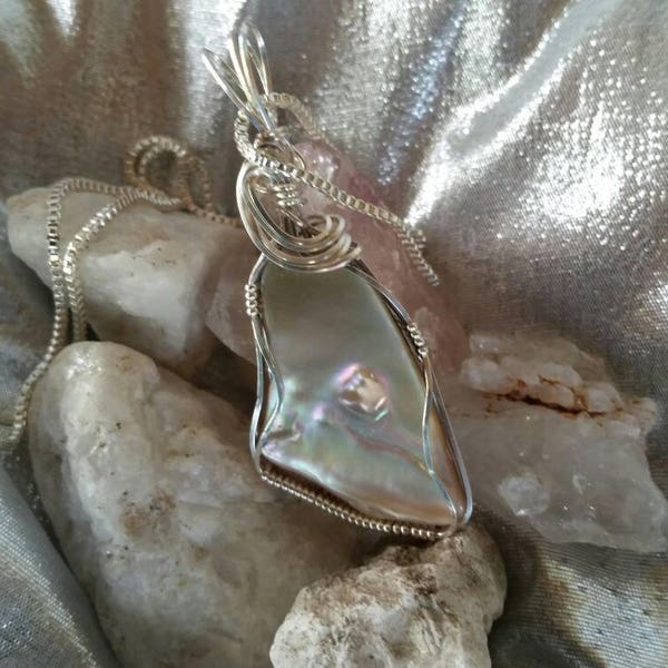 Red Abalone shell pendant wire wrapped in argentium silver wire.  Free form triangular shape shell pendant