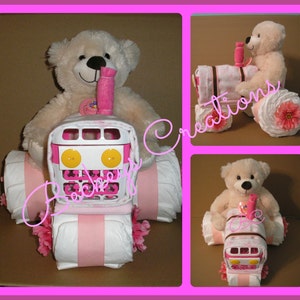 May include: A pink and white diaper cake shaped like a tractor with a teddy bear sitting in the driver's seat. The tractor has pink and white stripes and yellow wheels. The teddy bear is wearing a pink bow.