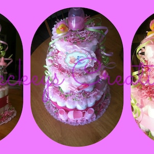 May include: A three-tiered diaper cake decorated with pink and green ribbons, bows, and flowers. The cake features Winnie the Pooh and Tigger characters, along with the words "Baby" on the bottom tier.