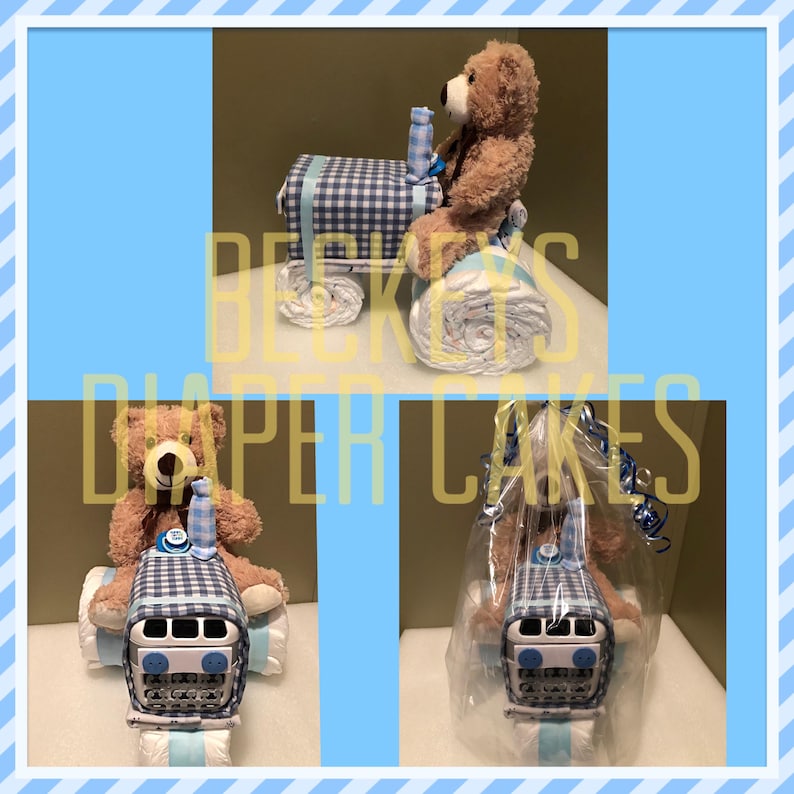 May include: A blue and white checkered diaper cake shaped like a tractor with a teddy bear sitting on top. The cake is decorated with blue and white ribbon and a blue bottle.