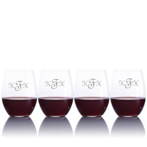May include: Four clear glass wine glasses with a red wine inside. Each glass has the monogram "KFH" etched on the front.