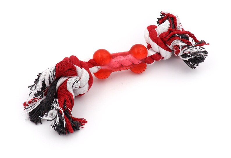 May include: Red, white, and black rope dog toy with a red rubber bone in the center.