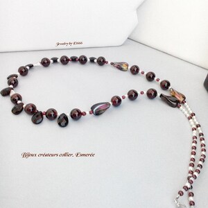 May include: A long, two-strand necklace with alternating red garnet and white pearl beads. The necklace features a silver clasp and a few larger, faceted garnet beads.