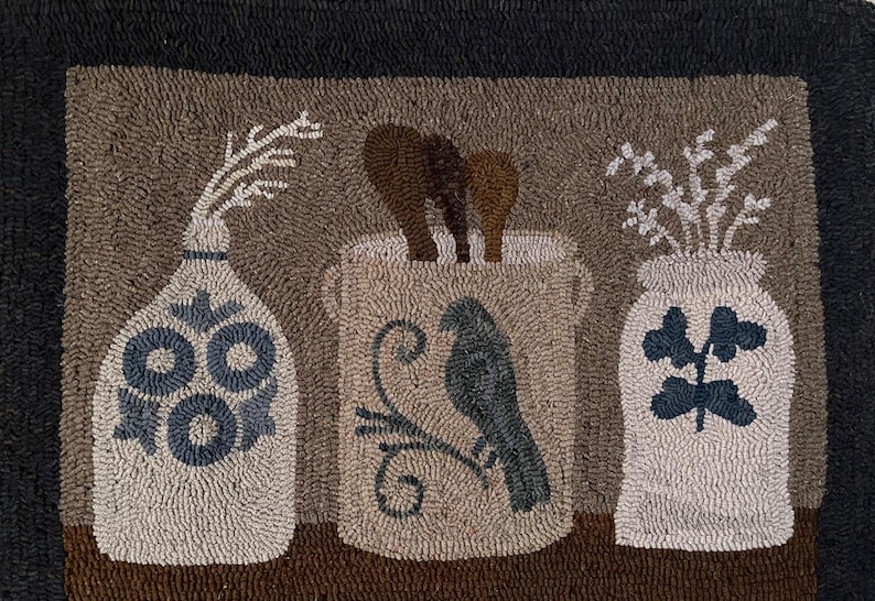 May include: A hand-hooked rug featuring three decorative jars. The jars are filled with wooden spoons, branches, and flowers. The rug has a neutral color palette with a black border.