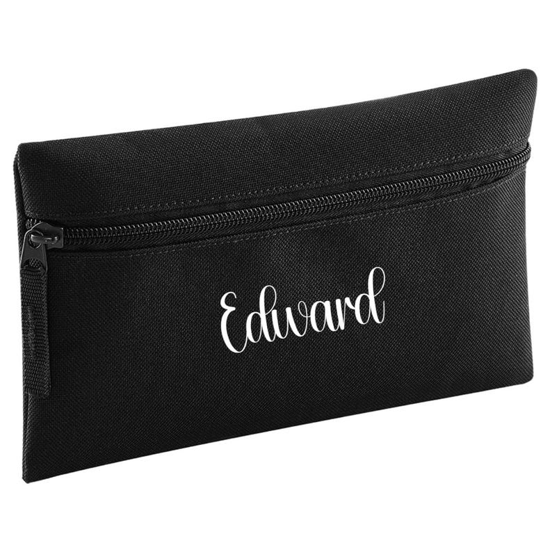 Personalised black pencil case with zip closure, customised with a child's name in white vinyl. Durable 600D polyester school pencil case for pens, pencils and stationery, ideal for school, nursery and back to school essentials.