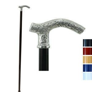 May include: A silver-coloured walking stick with a decorative handle featuring an intricate floral design. The stick has a black shaft and a brown tip.