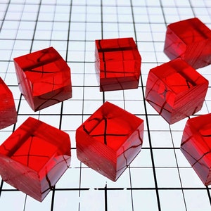 May include: Ten red, translucent, cube-shaped objects with a slightly textured surface. The cubes are arranged in a staggered pattern on a white grid background.