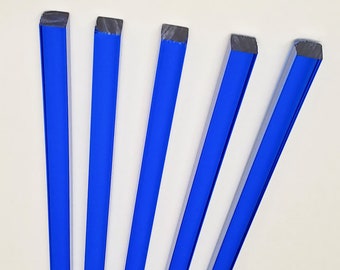 May include: Five blue glass rods with a square cross-section.