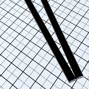 May include: Two black dowel rods, approximately 12 inches long, are lying on a white grid background.