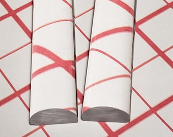 May include: Two clear glass rods with a red and white striped pattern. The rods are slightly curved at the ends.