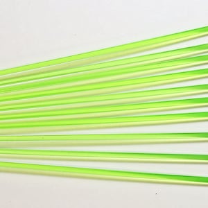 May include: A bundle of 12 green and white glass rods. The rods are translucent and have a slight shimmer.