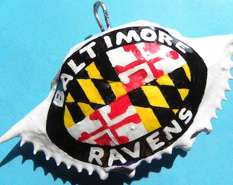 Maryland State seal with Baltimore Ravens written around the oval handpainted on a Maryland crab ornament