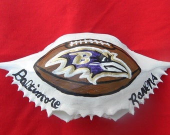 Baltimore Raven on a Football hand painted Christmas crab shell ornamentIt comes packaged in a plastic container with coordinated shred