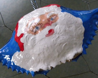 Santa Claus face on blue background handpainted on a Maryland crab shell ornament