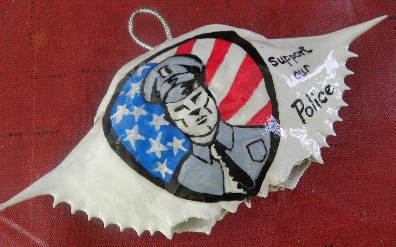 Logo Support Our Police American flag painted on a Maryland crab shell ornament. Packaged in a plastic container with coordinated shred image 1