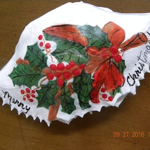 Christmas Holly Painted Crab shell. Packaged in a plastic container with coordinated shred