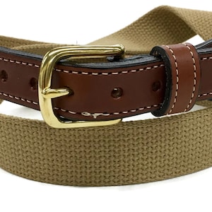 May include: A brown leather belt with a gold buckle and a tan canvas strap.