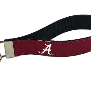 May include: Crimson red key chain with a black strap and a white "A" logo.