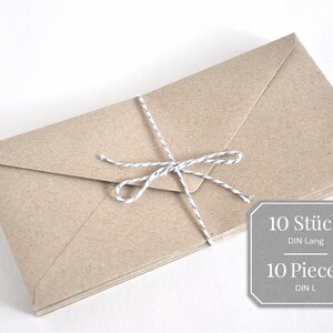 May include: A stack of 10 brown envelopes tied together with a white twine bow. The label reads "10 St&uuml;ck DIN Lang" and "10 Pieces DIN L".