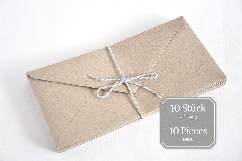 May include: A stack of 10 brown envelopes tied together with a white twine bow. The label reads "10 St&uuml;ck DIN Lang" and "10 Pieces DIN L".