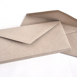 May include: A stack of brown kraft paper envelopes. The envelopes are folded and ready to be used for mailing letters or cards.