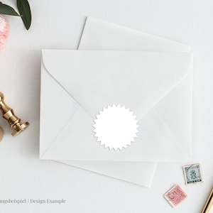 May include: A white envelope with a white, star-shaped seal. The envelope is on a white surface with a gold pen, a gold wax seal, and a pink rose.