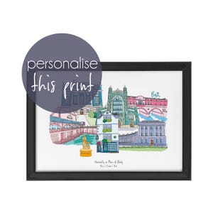 May include: A framed print with a colourful illustration of Bath landmarks. The artwork includes buildings, a statue, and the word "Bath". A dark blue circle with the text "personalise this print" is in the upper left corner.