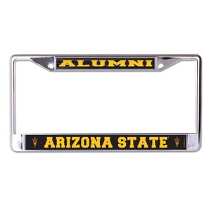 May include: A chrome license plate frame with a black background and gold text. The top of the frame says "ALUMNI" and the bottom says "ARIZONA STATE" with a gold sun devil logo on each side.