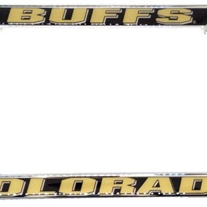 May include: A silver license plate frame with a black background and gold lettering. The top of the frame says "BUFFS" and the bottom says "COLORADO".