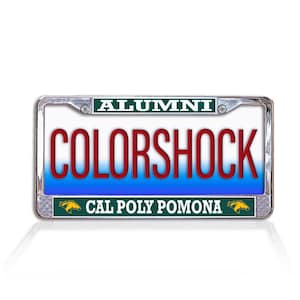 May include: A rectangular license plate frame with the word "ALUMNI" at the top and "CAL POLY POMONA" at the bottom. The center features the word "COLORSHOCK" in red letters against a blue and white background. The frame is silver.