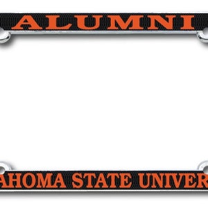 May include: A chrome license plate frame with the words "ALUMNI" and "OKLAHOMA STATE UNIVERSITY" in orange lettering on a black background. The frame has four mounting holes.