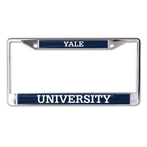 May include: A chrome license plate frame with a navy blue background and white text that reads "YALE UNIVERSITY".