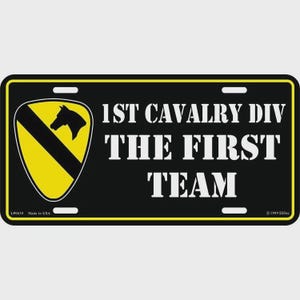 May include: Black license plate with yellow border and text "1ST CAVALRY DIV THE FIRST TEAM." Features a yellow shield with a black diagonal stripe and a black horse head. Made in USA.