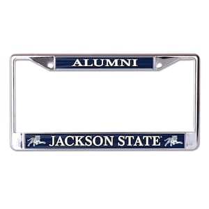 May include: A chrome license plate frame with a blue background and white text. The top of the frame says "ALUMNI" and the bottom says "JACKSON STATE" with a white tiger on each side of the text.