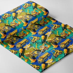 May include: A rolled fabric featuring a repeating pattern of yellow construction vehicles, traffic cones, and tools on a blue, green, and yellow background. The fabric has a diagonal orientation and a slight sheen.