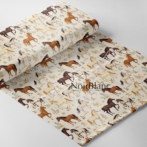 May include: A roll of fabric with a repeating pattern of horses in brown, white, and black on a cream background. The fabric displays a detailed illustration of horses and foliage, with the text "NoirBlanc" visible.