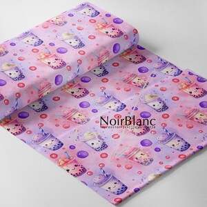 May include: Pink fabric with a repeating pattern of cartoon bubble tea cups with smiling faces. The cups are filled with colourful tapioca pearls and topped with whipped cream, fruit, and straws. The background is a light pink and purple ombre with small pink and purple polka dots.
