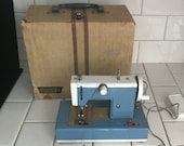 Child size BROTHER sewing machine Blue white metal original 1930 39 s hand crank or battery operated In Original Case collectible display