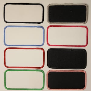 May include: Eight blank rectangular patches with different colored borders. The patches are white with black, gray, blue, red, green, and pink borders.