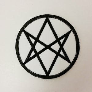May include: A white embroidered patch with a black six-pointed star in the center. The star is made up of overlapping triangles.